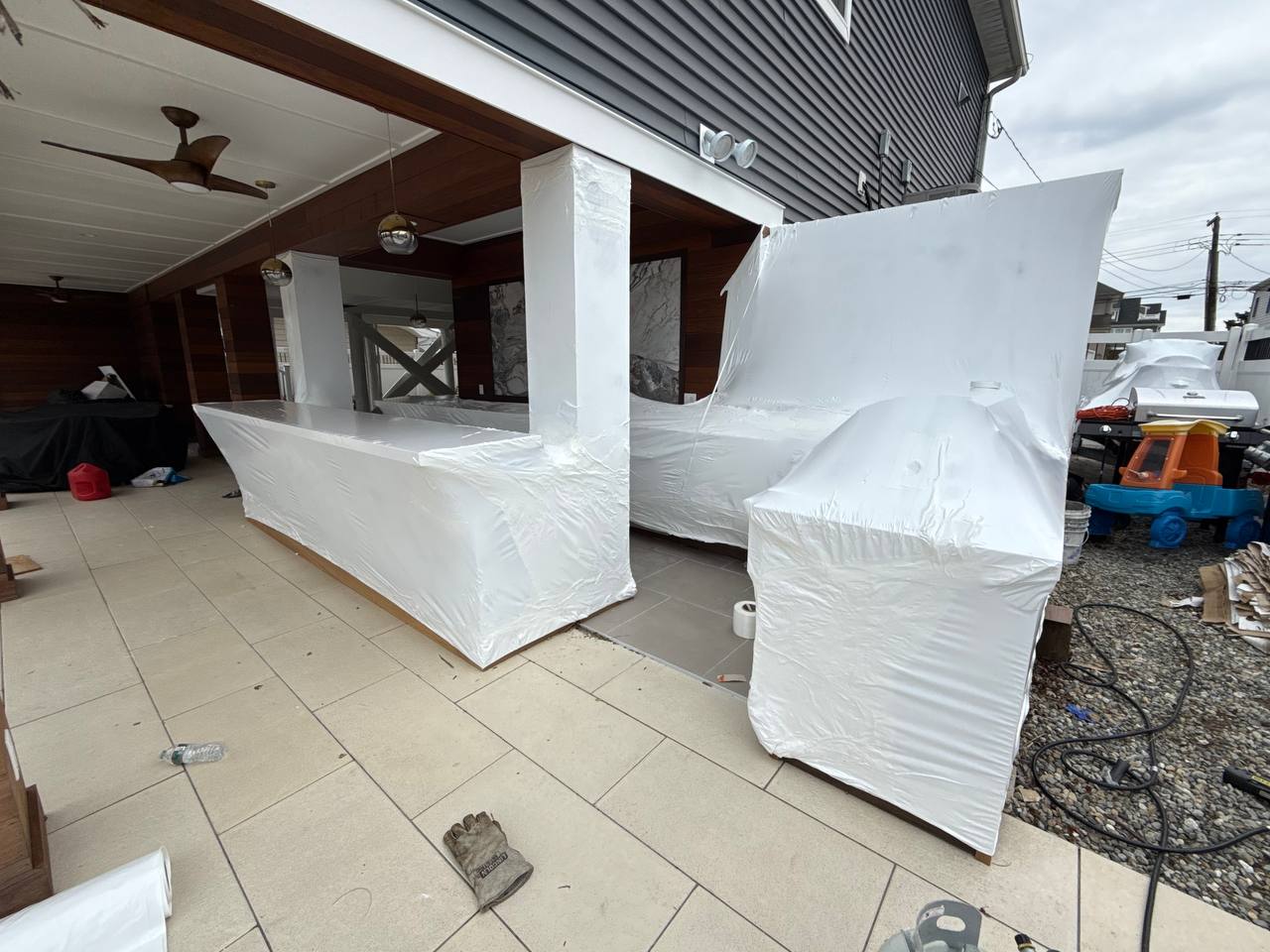 Luxury outdoor kitchen and bar shrink wrapped for winter